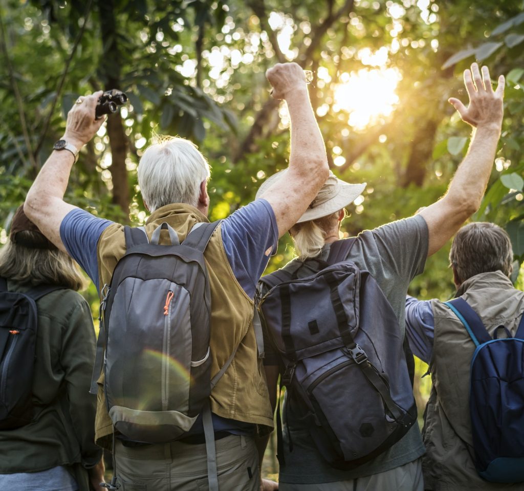 group-of-senior-adults-trekking-in-the-forest.jpg